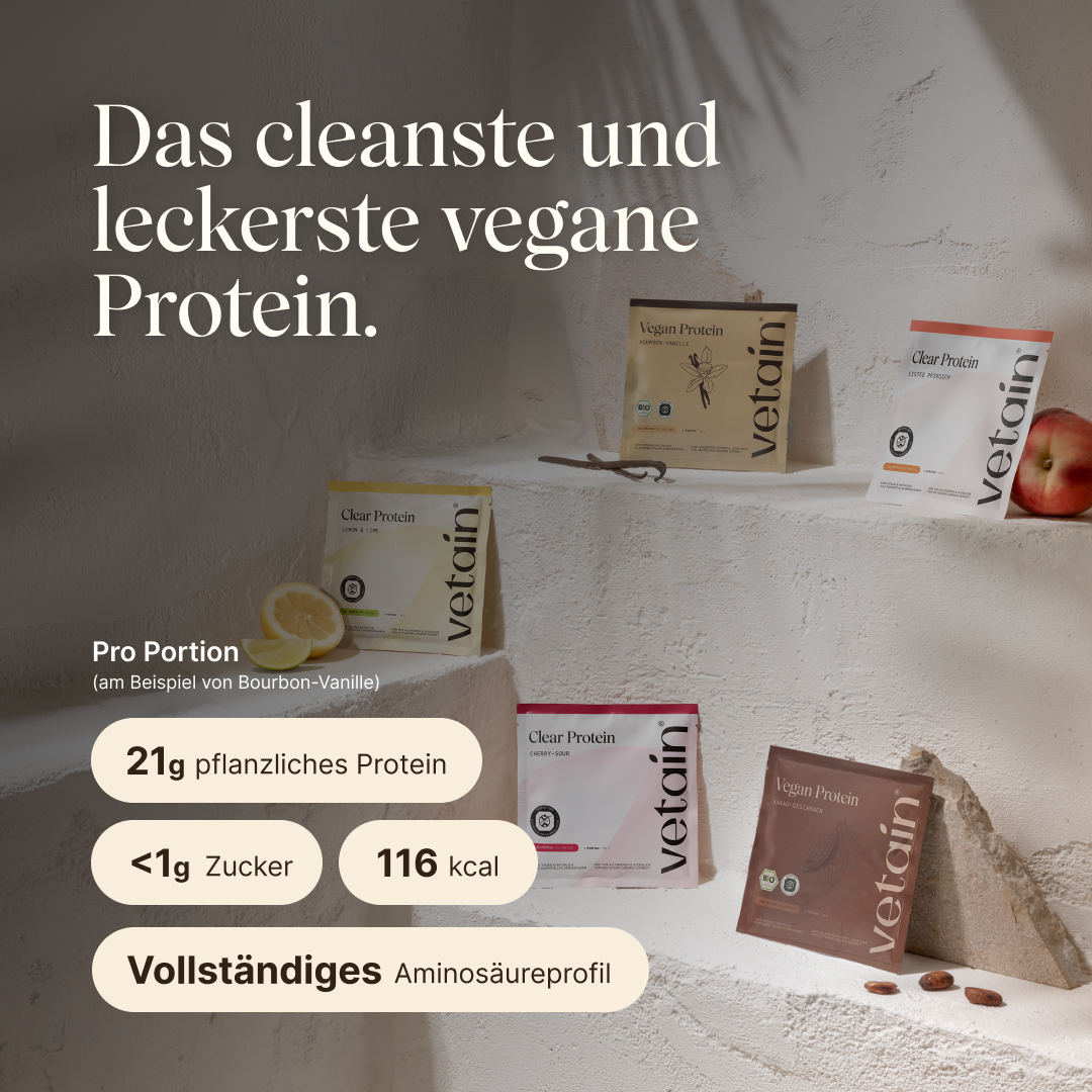 Mehrere Probierportionen von vetain Vegan Protein und Clear Protein in verschiedenen Sorten – darunter Bourbon-Vanille, Kakao-Geschmack, Lemon & Lime, Cherry-Sour und Eistee Pfirsich – verteilt auf hellen Stufen, dekoriert mit Zitrone, Pfirsich und Kakaobohnen. Überschrift: ‚Das cleanste und leckerste vegane Protein.' Angaben pro Portion am Beispiel Bourbon-Vanille: 21 g pflanzliches Protein, unter 1 g Zucker, 116 kcal, vollständiges Aminosäureprofil.