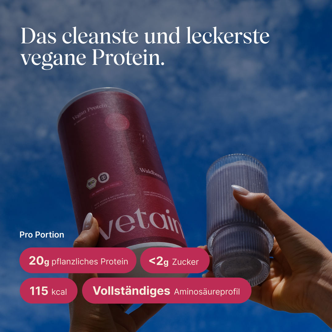 Hand hält eine Dose vetain Vegan Protein in der Geschmacksrichtung Waldbeere gegen blauen Himmel, daneben ein Glas mit fertig zubereitetem Proteinshake. Überschrift: ‚Das cleanste und leckerste vegane Protein.' Angaben pro Portion: 20 g pflanzliches Protein, unter 2 g Zucker, 115 kcal, vollständiges Aminosäureprofil