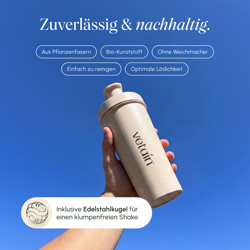 Hand holding a beige vetain shaker against a blue sky; Features: made from plant fibers, bio-plastic, free of plasticizers, easy to clean, optimal solubility, includes a stainless steel ball for a lump-free shake.