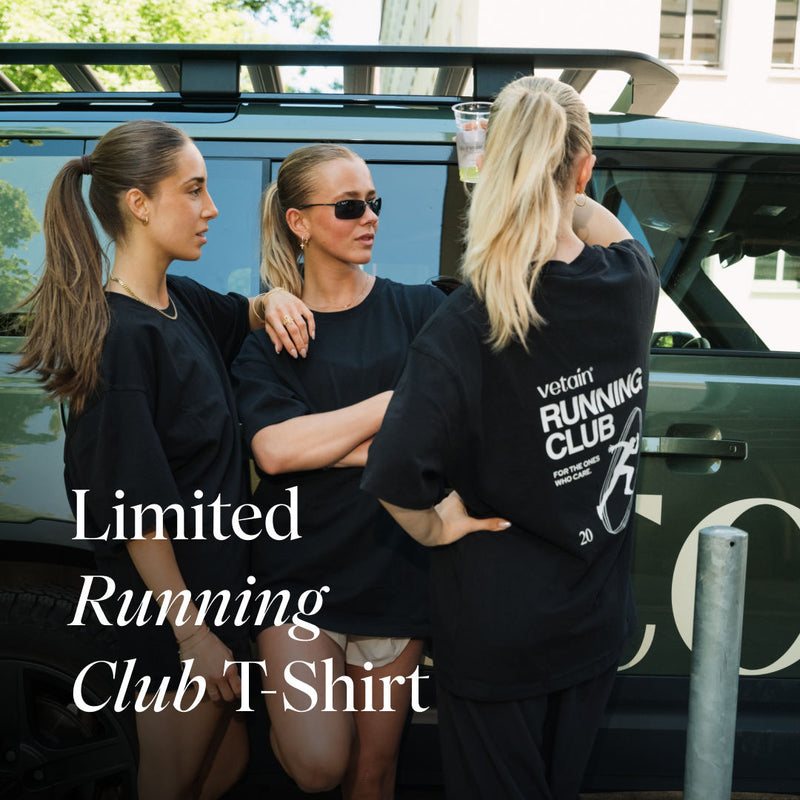 Three women in black Vetain Running Club T-shirts stand by a dark green SUV, one seen from behind showing the back print. Text: "Limited Running Club T-Shirt."