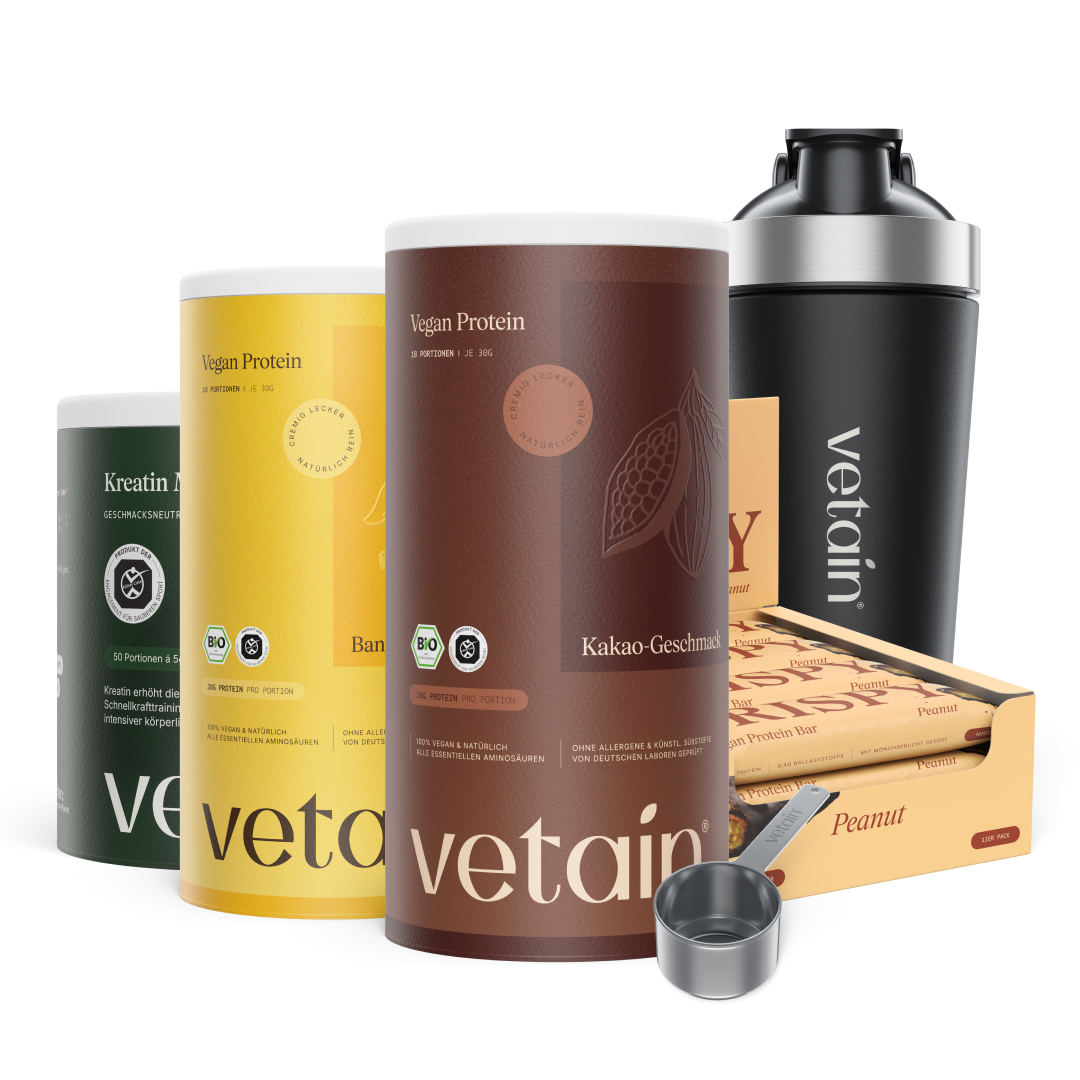 Vetain Bundle freigestellt vor weißem Hintergrund: Kreatin-Dose, Vegan Protein Banane und Kakao, ein 12er Crispy Peanut Karton, schwarzer Shaker und Dosierlöffel.