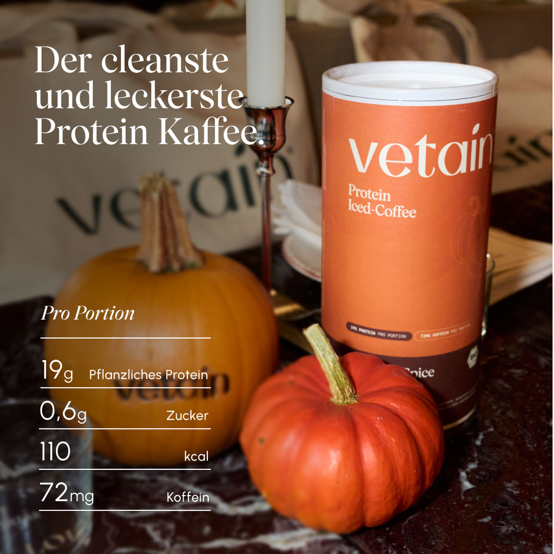 Vetain Protein Iced-Coffee Pumpkin-Spice Dose auf einem Tisch mit Kürbissen und Kerze. Überschrift „Der cleanste und leckerste Protein Kaffee.“ Nährwerte pro Portion: 19 g pflanzliches Protein, 0,6 g Zucker, 110 kcal, 72 mg Koffein.